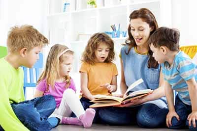 Teacher Working with Kids on Reading Skills